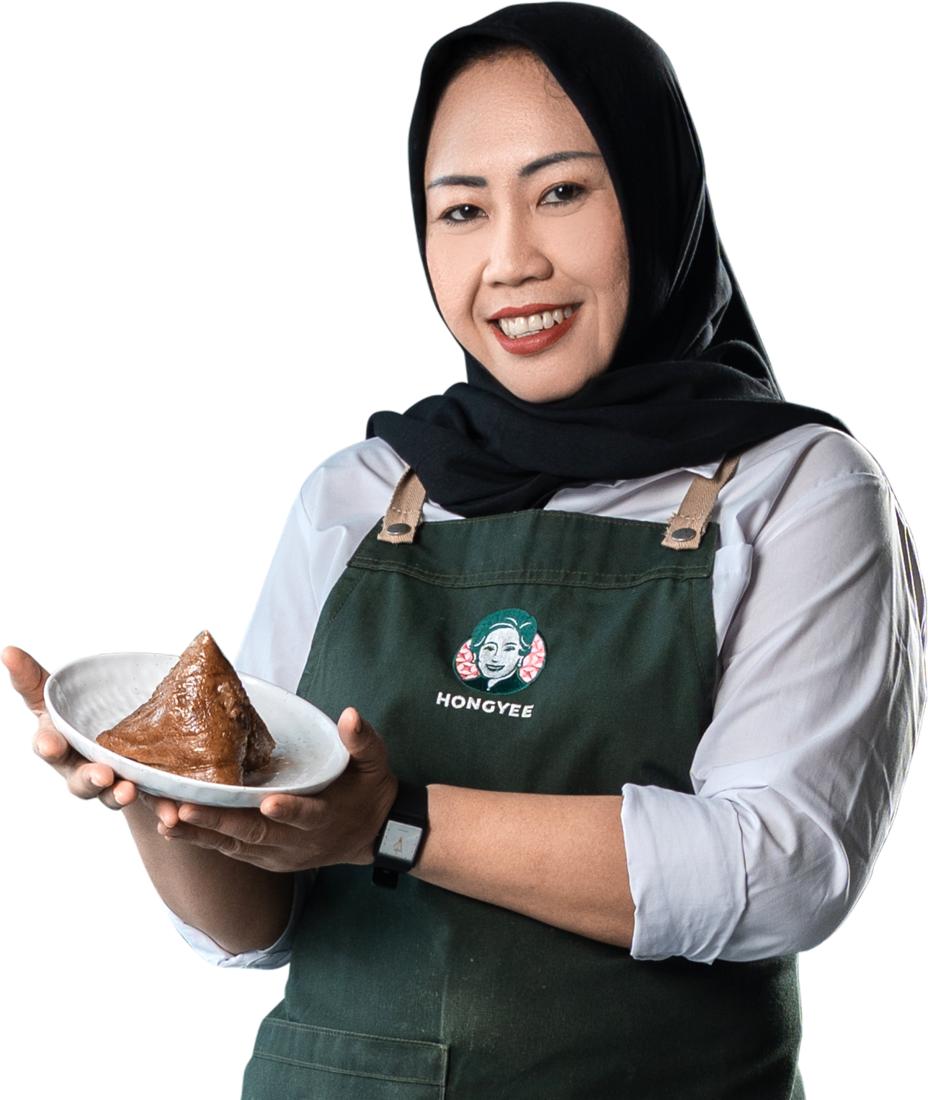 HONGYEE's next generation, holding a freshly wrapped kuih chang